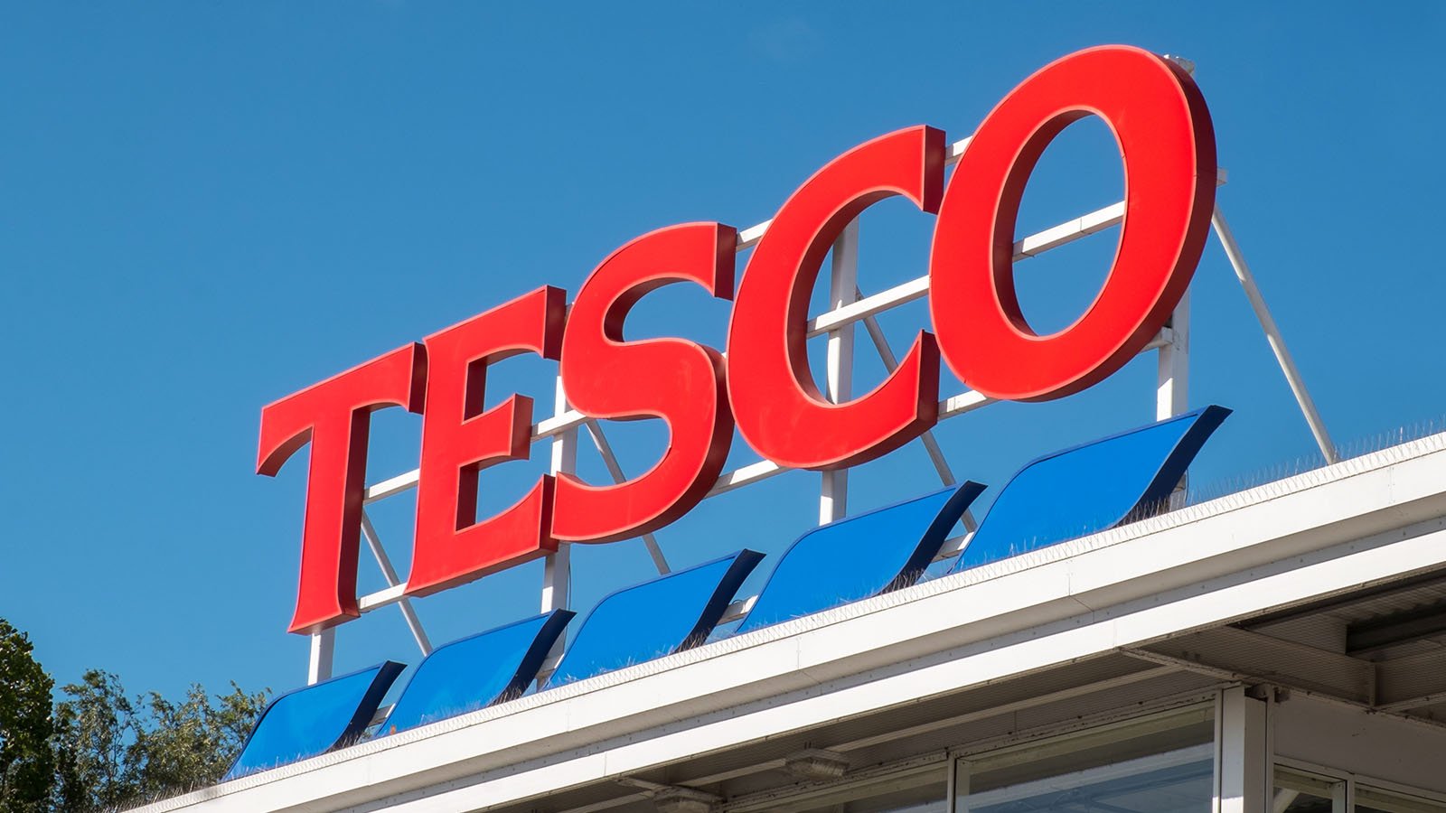 Tesco supermarket sign atop a store exterior